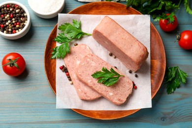 Photo of Pieces of tasty canned meat, parsley, spices and tomatoes on light blue wooden table, flat lay