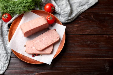 Photo of Pieces of tasty canned meat, tomatoes, dill and peppercorns on wooden table, flat lay. Space for text