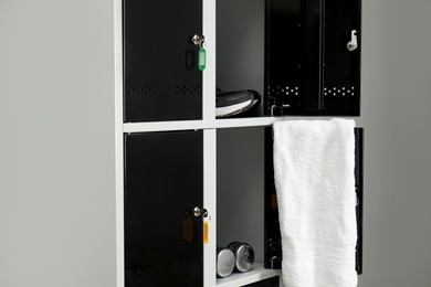 Lockers with personal belongings in changing room at gym, closeup