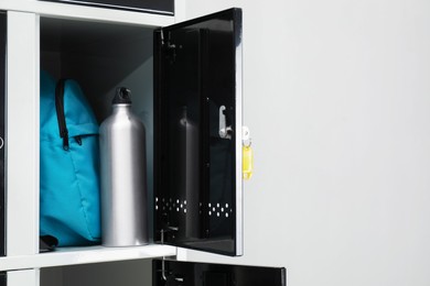 Lockers with personal belongings in changing room at gym, closeup