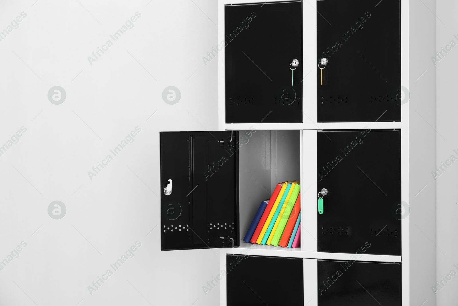 Photo of Lockers with school supplies on light background