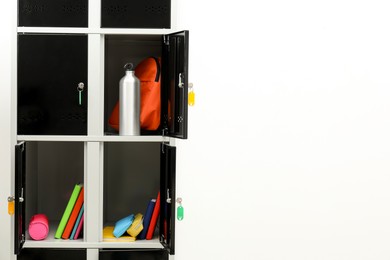 Photo of Lockers with school supplies on light background, closeup. Space for text