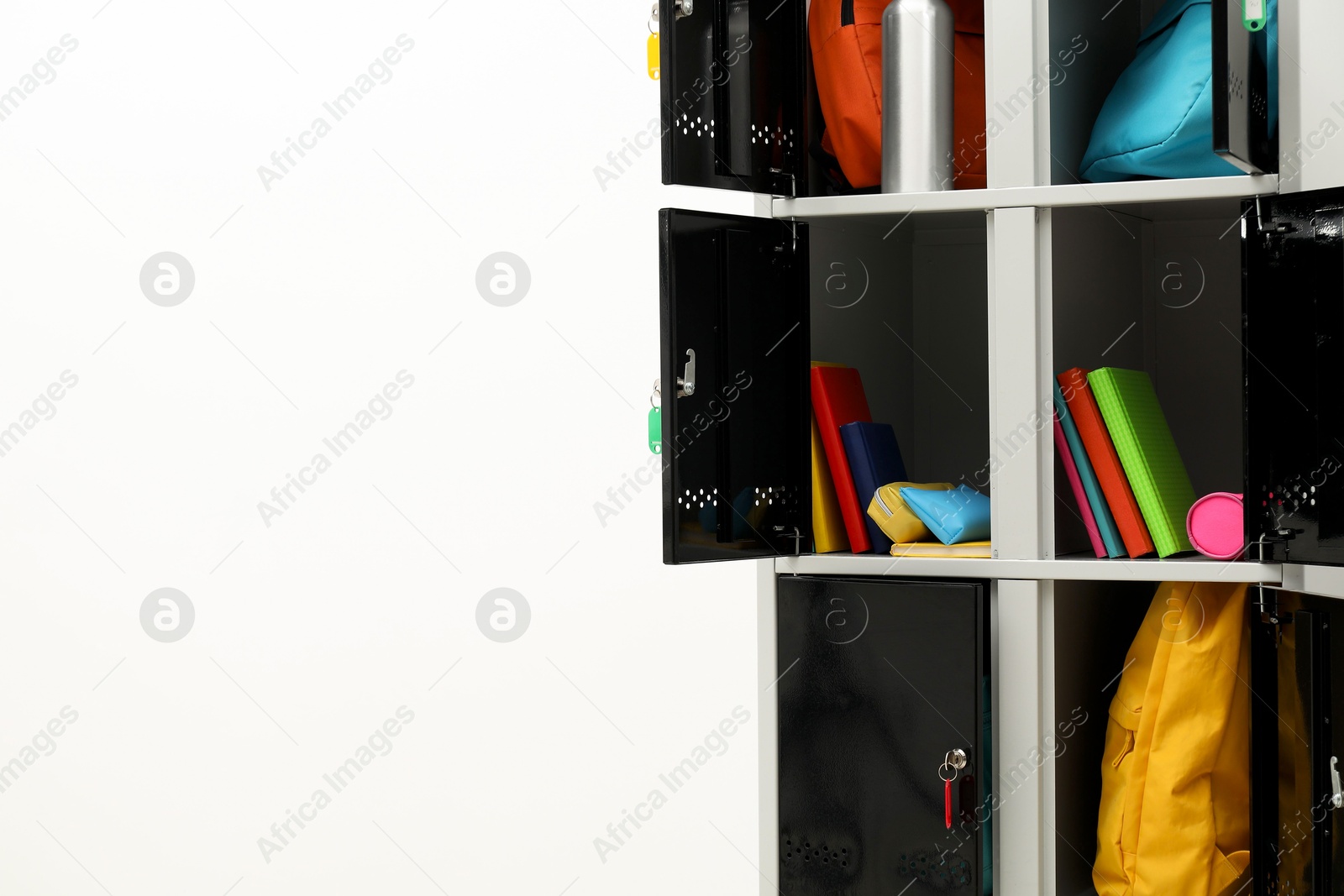 Photo of Lockers with school supplies on light background, closeup. Space for text