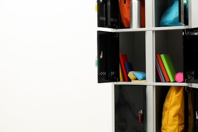 Photo of Lockers with school supplies on light background, closeup. Space for text