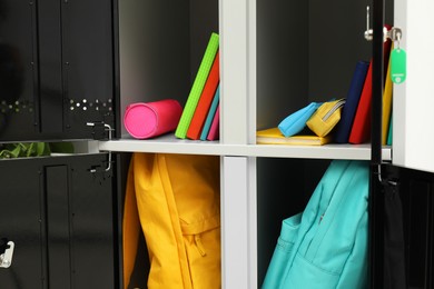 Photo of Lockers with school supplies on light background, closeup