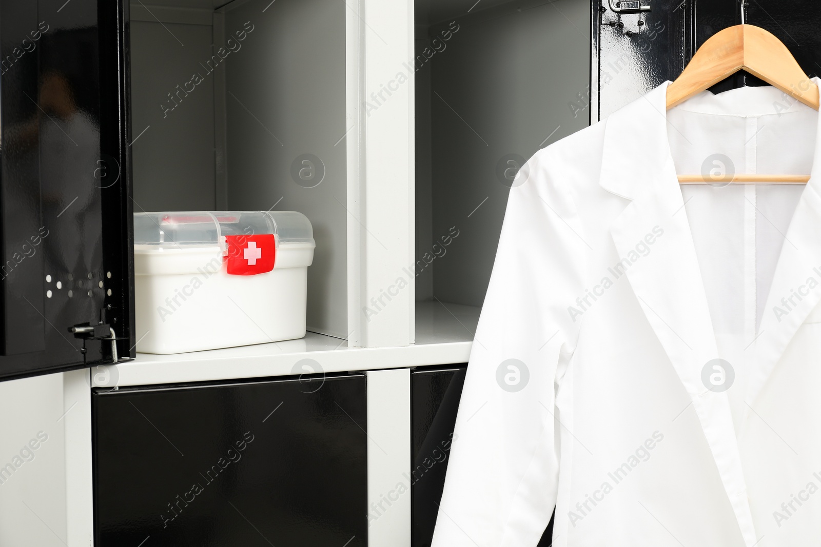 Photo of Medical personnel uniform on locker in changing room, closeup