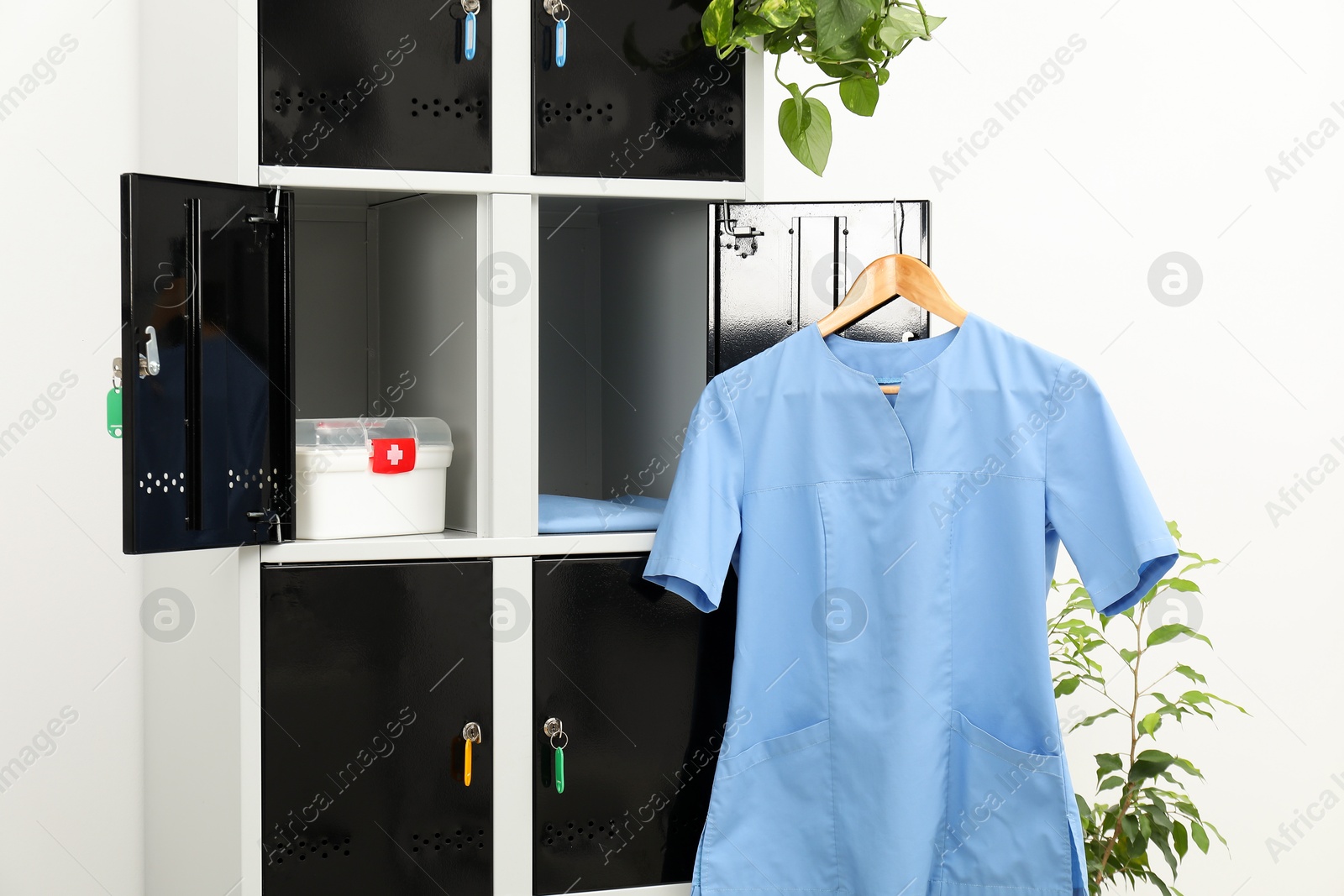 Photo of Medical personnel uniform on locker in changing room