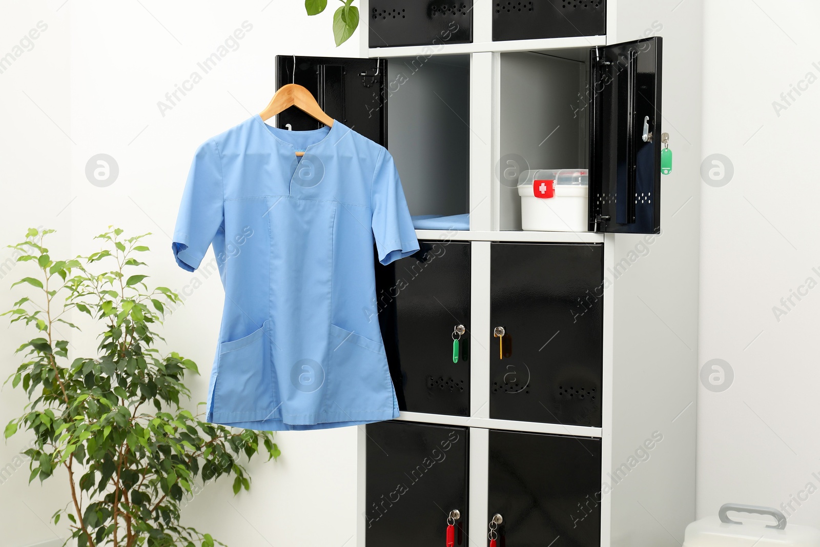 Photo of Medical personnel uniform on locker in changing room