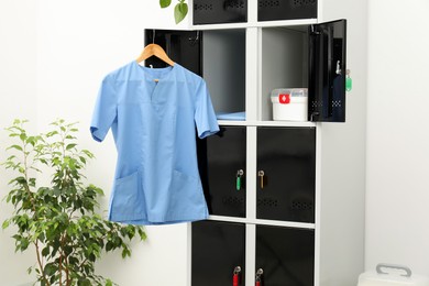 Photo of Medical personnel uniform on locker in changing room