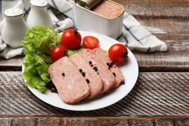 Photo of Tasty canned meat, tomatoes, lettuce and spices on wooden table