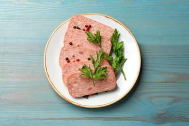 Tasty canned meat, parsley and peppercorns on light blue wooden table, top view