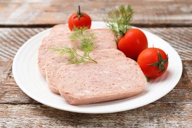 Photo of Tasty canned meat, tomatoes and dill on wooden table, closeup