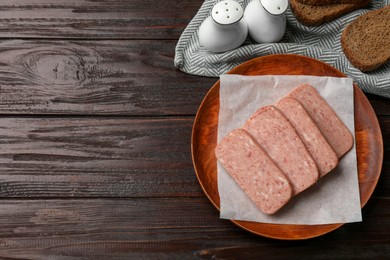 Photo of Canned meat and bread on wooden table, top view. Space for text