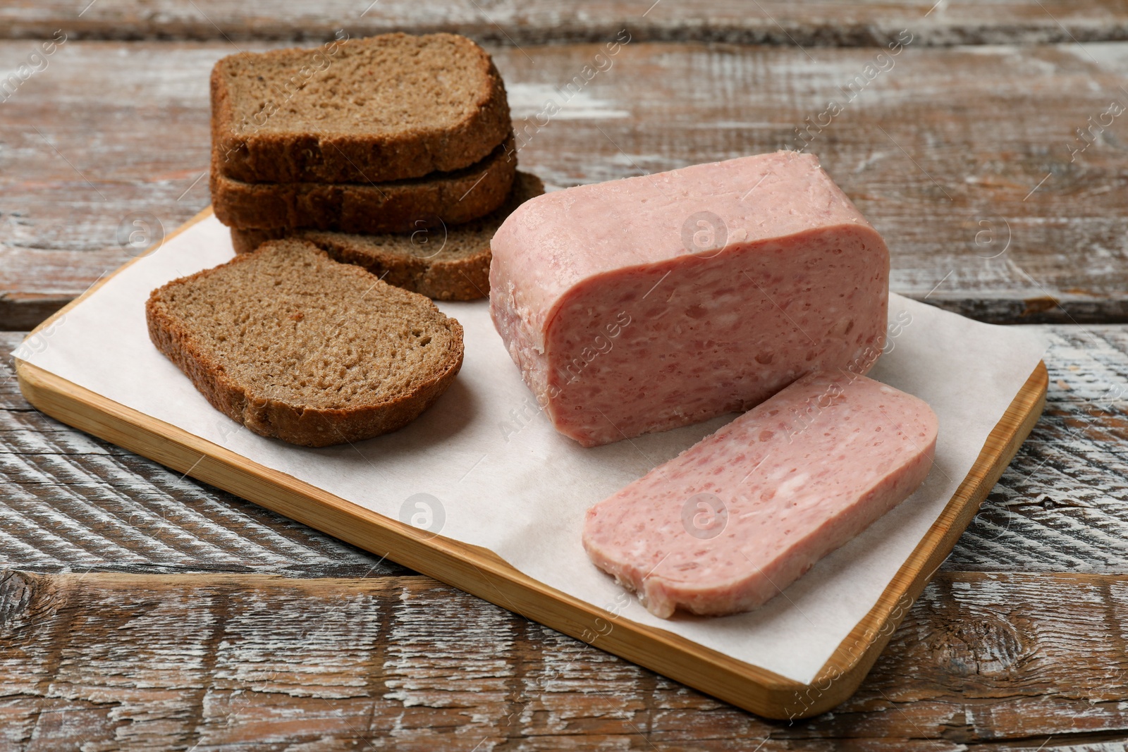 Photo of Canned meat and bread on wooden table, closeup