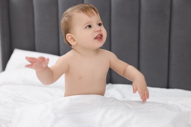 Photo of Cute little baby on bed at home