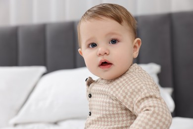 Photo of Cute little baby on bed at home