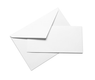 Photo of Envelope with card isolated on white, top view. Mockup for design