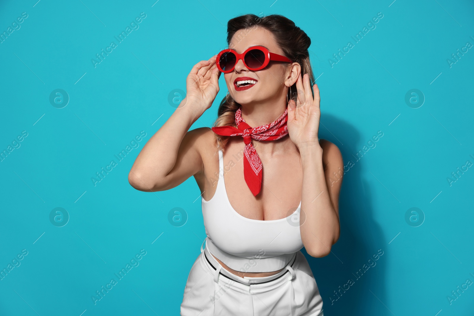 Photo of Happy pin-up woman on light blue background