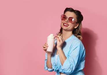 Photo of Happy pin-up woman with milk shake on pink background. Space for text