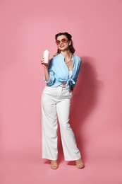 Photo of Happy pin-up woman with milk shake on pink background