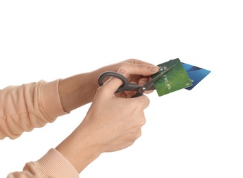 Photo of Woman cutting credit cards on white background, closeup