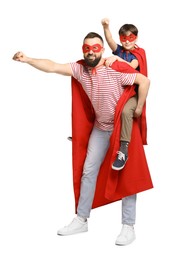 Photo of Father and his son wearing superhero costumes on white background