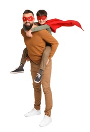 Photo of Father and his son wearing superhero costumes on white background