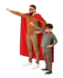 Photo of Father and his son wearing superhero costumes on white background