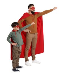 Photo of Father and his son wearing superhero costumes on white background