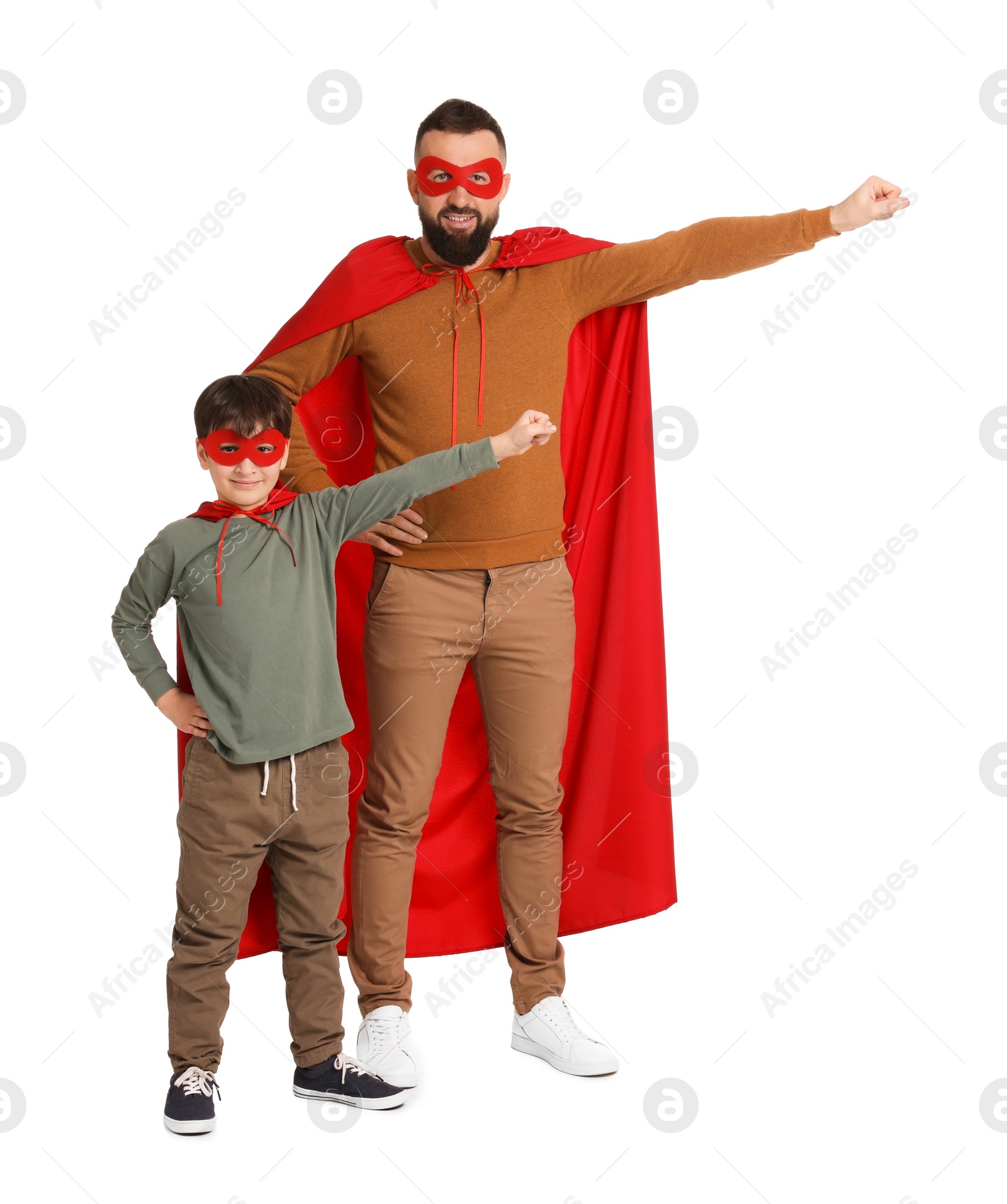 Photo of Father and his son wearing superhero costumes on white background