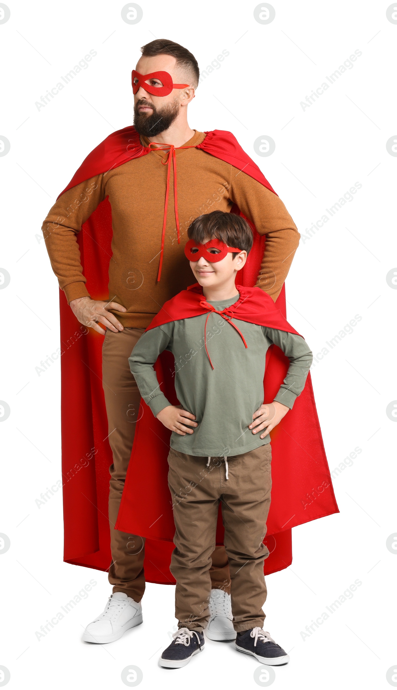 Photo of Father and his son wearing superhero costumes on white background