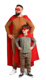 Photo of Father and his son wearing superhero costumes on white background