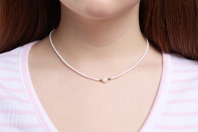 Photo of Teenage girl wearing stylish necklace, closeup. Elegant jewellery