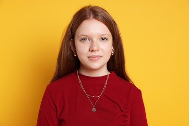 Photo of Teenage girl wearing stylish jewellery on yellow background