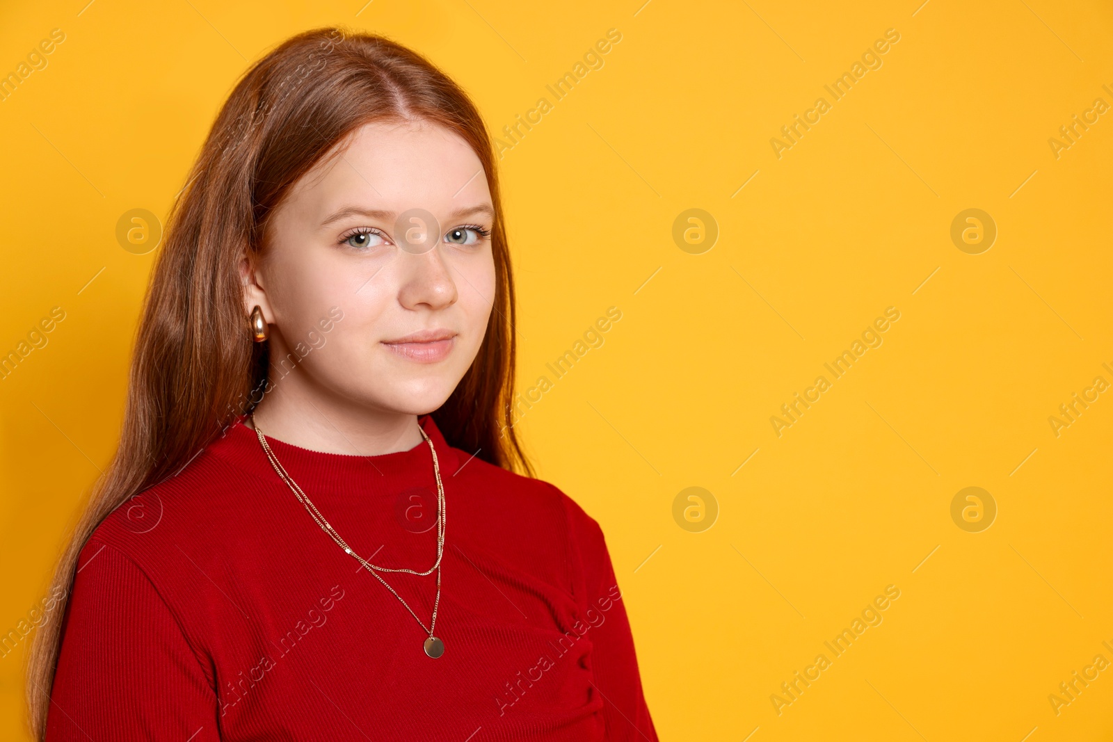 Photo of Teenage girl wearing stylish jewellery on yellow background, space for text