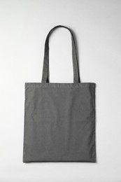 Photo of One shopping bag on grey background, top view. Mockup for design