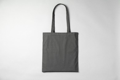 Photo of One shopping bag on grey background, top view. Mockup for design