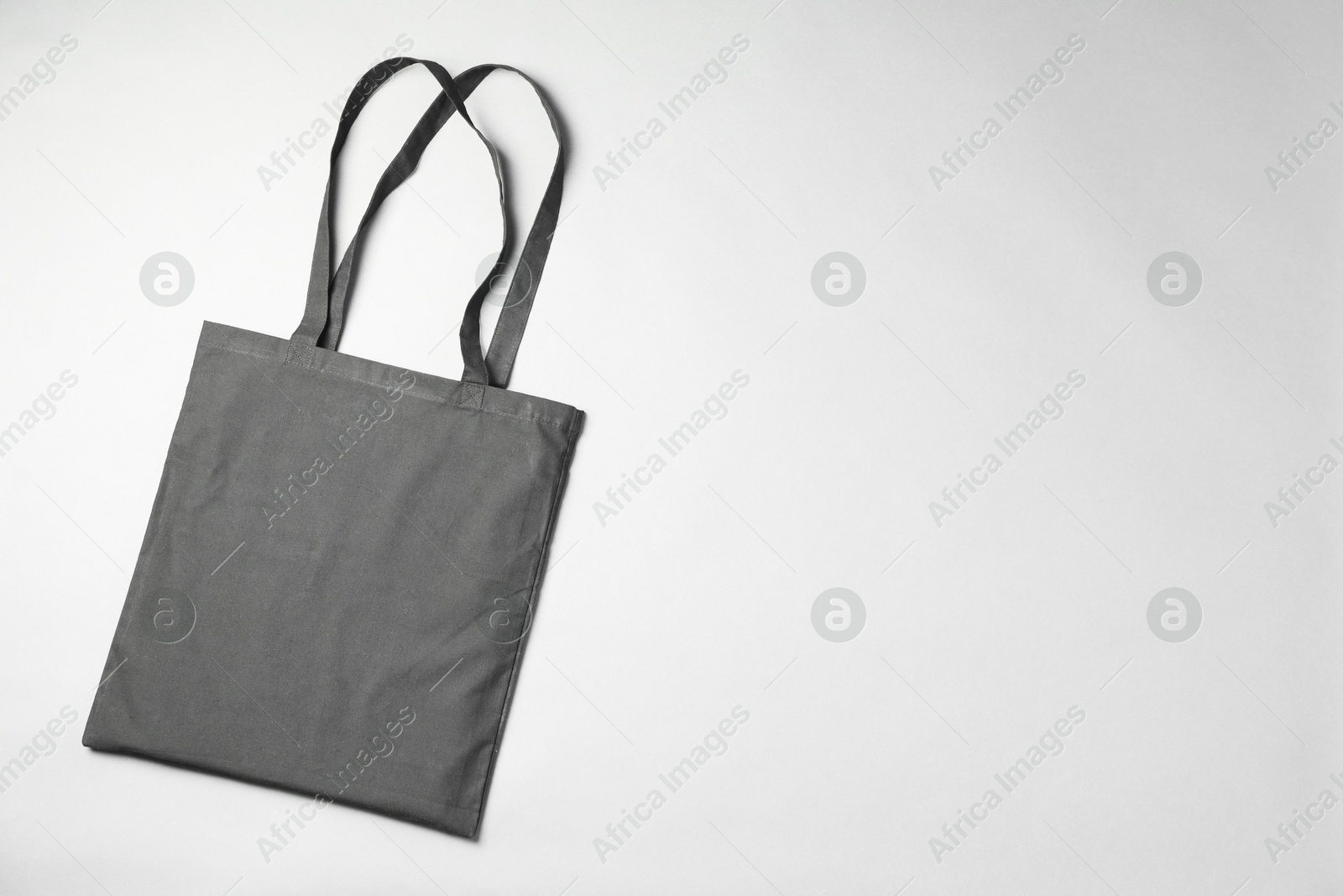 Photo of One shopping bag and space for text on grey background, top view. Mockup for design