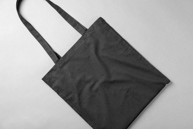 Photo of One shopping bag on grey background, top view. Mockup for design