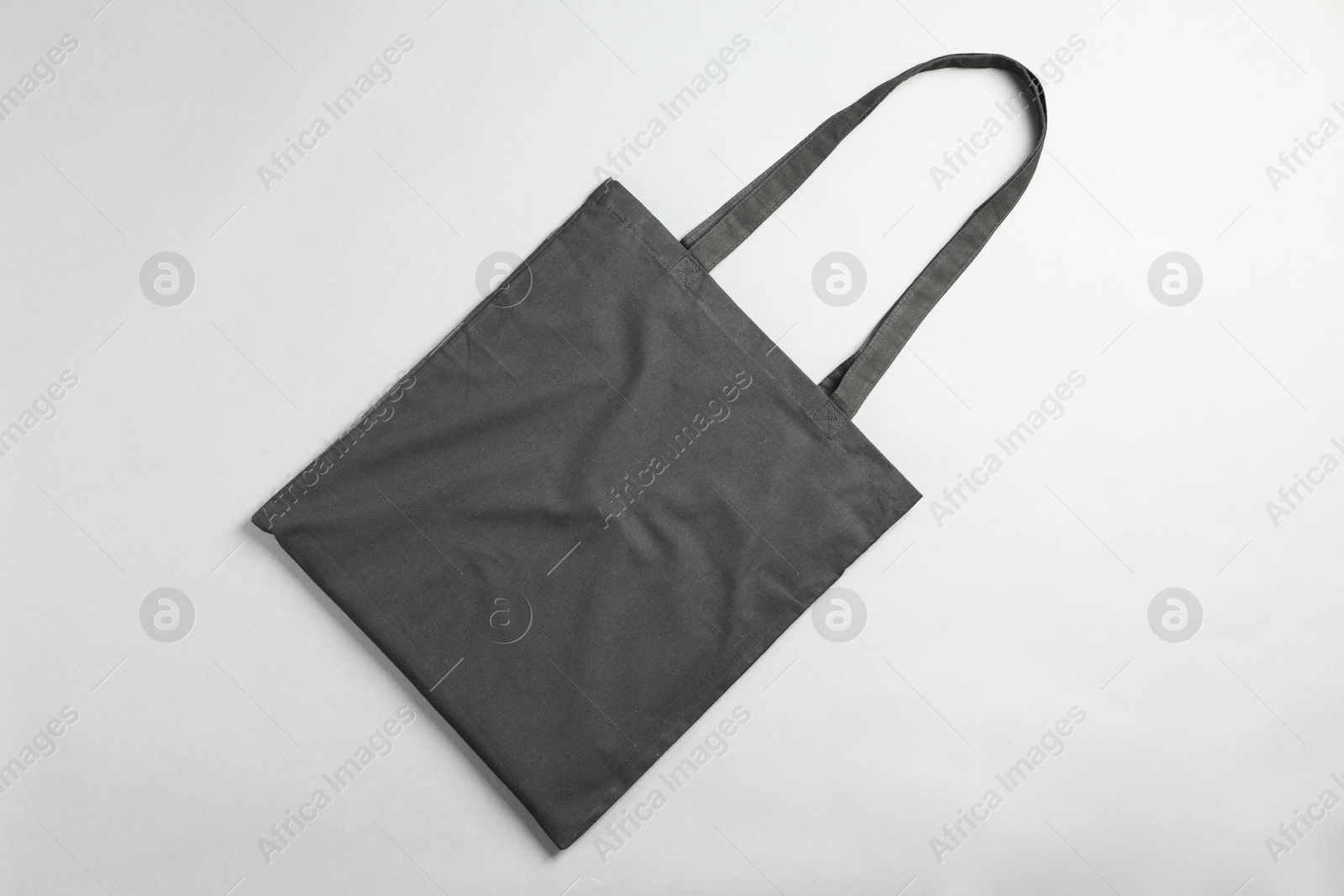 Photo of One shopping bag on grey background, top view. Mockup for design