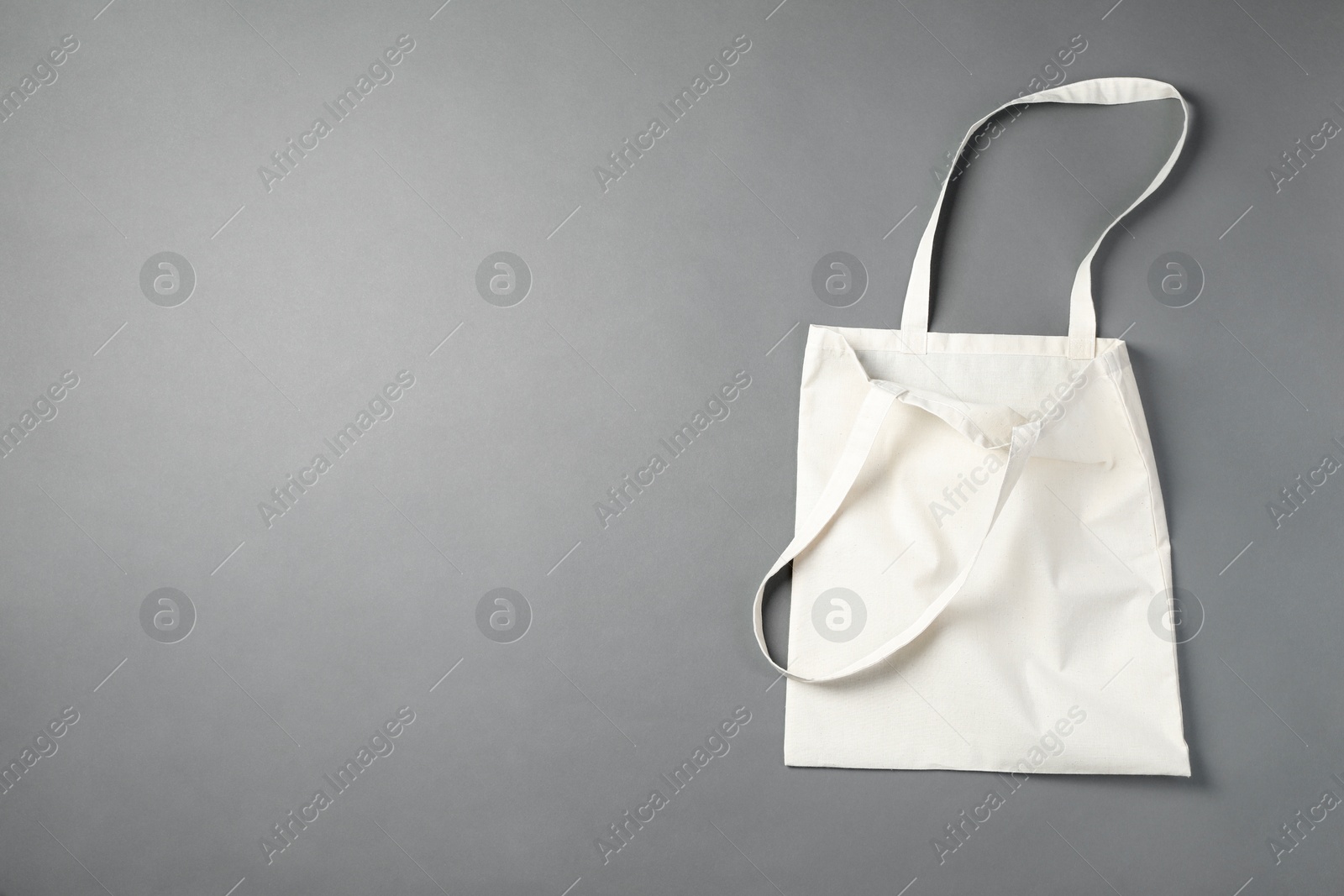 Photo of One shopping bag and space for text on grey background, top view. Mockup for design