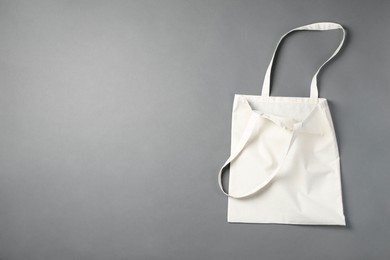 Photo of One shopping bag and space for text on grey background, top view. Mockup for design