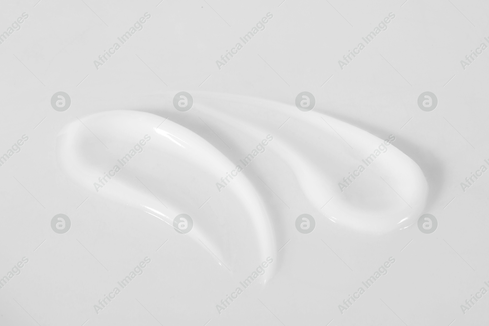 Photo of Smears of cosmetic product on white background, closeup