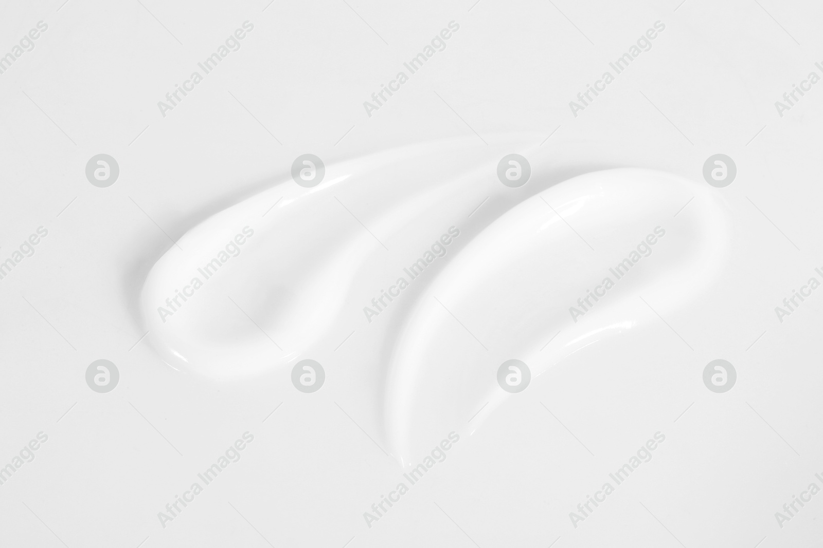 Photo of Smears of cosmetic product on white background, closeup