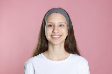 Photo of Teenage girl with acne problem on pink background