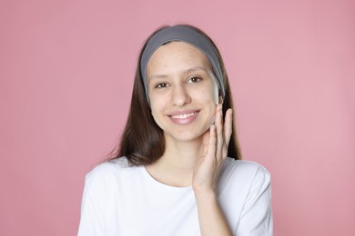 Photo of Teenage girl with acne problem on pink background