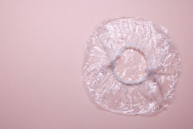 Photo of One shower cap on beige background, top view. Space for text