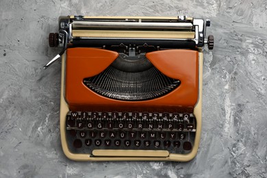 Photo of Vintage typewriter on grey background, top view