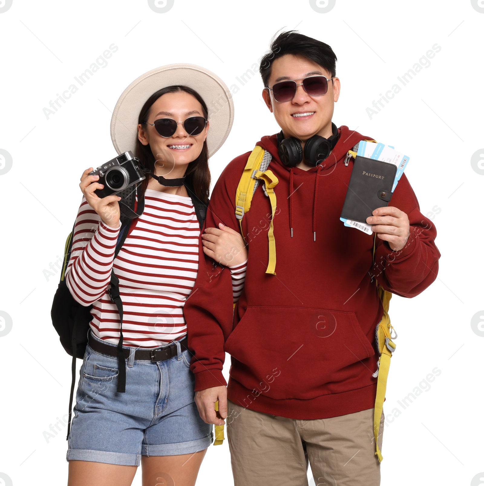 Photo of Happy travellers with passports and camera on white background