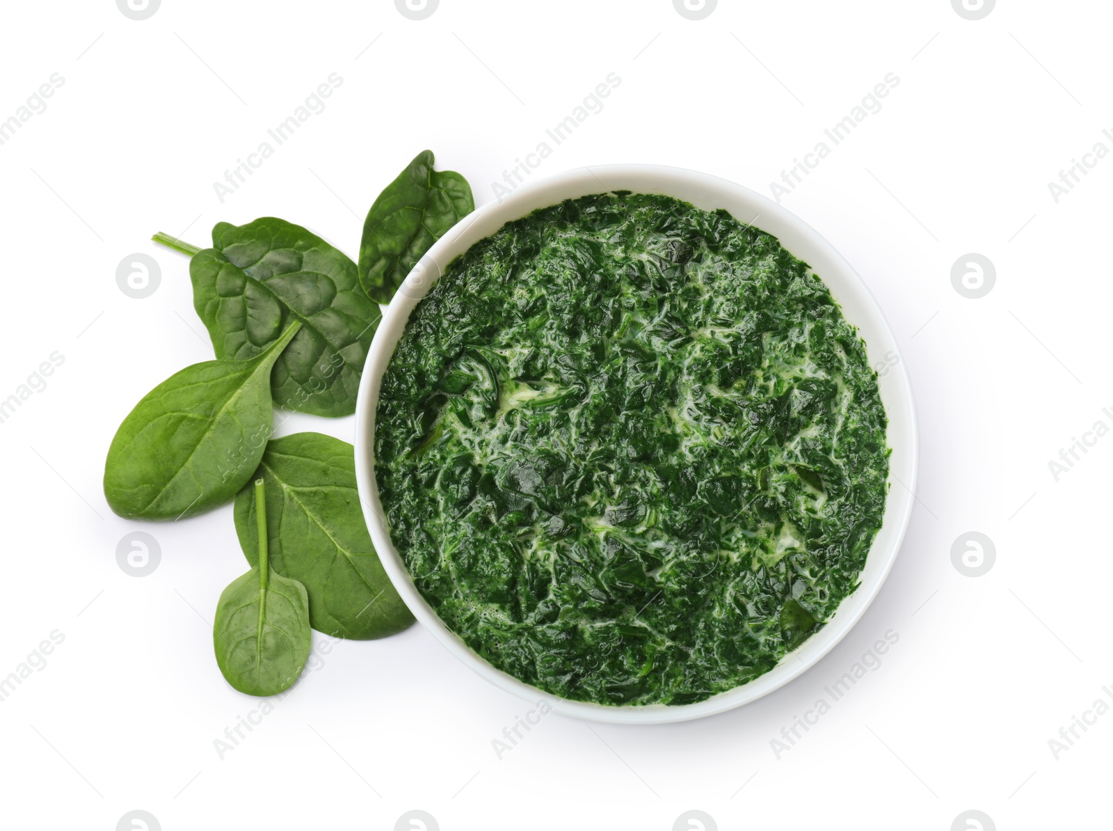 Photo of Delicious spinach sauce in bowl and leaves isolated on white, top view